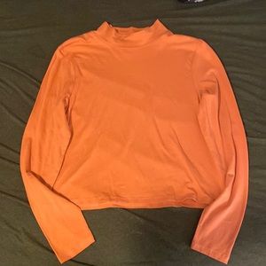 Thin long sleeve, rosy-orangey color. Never worn